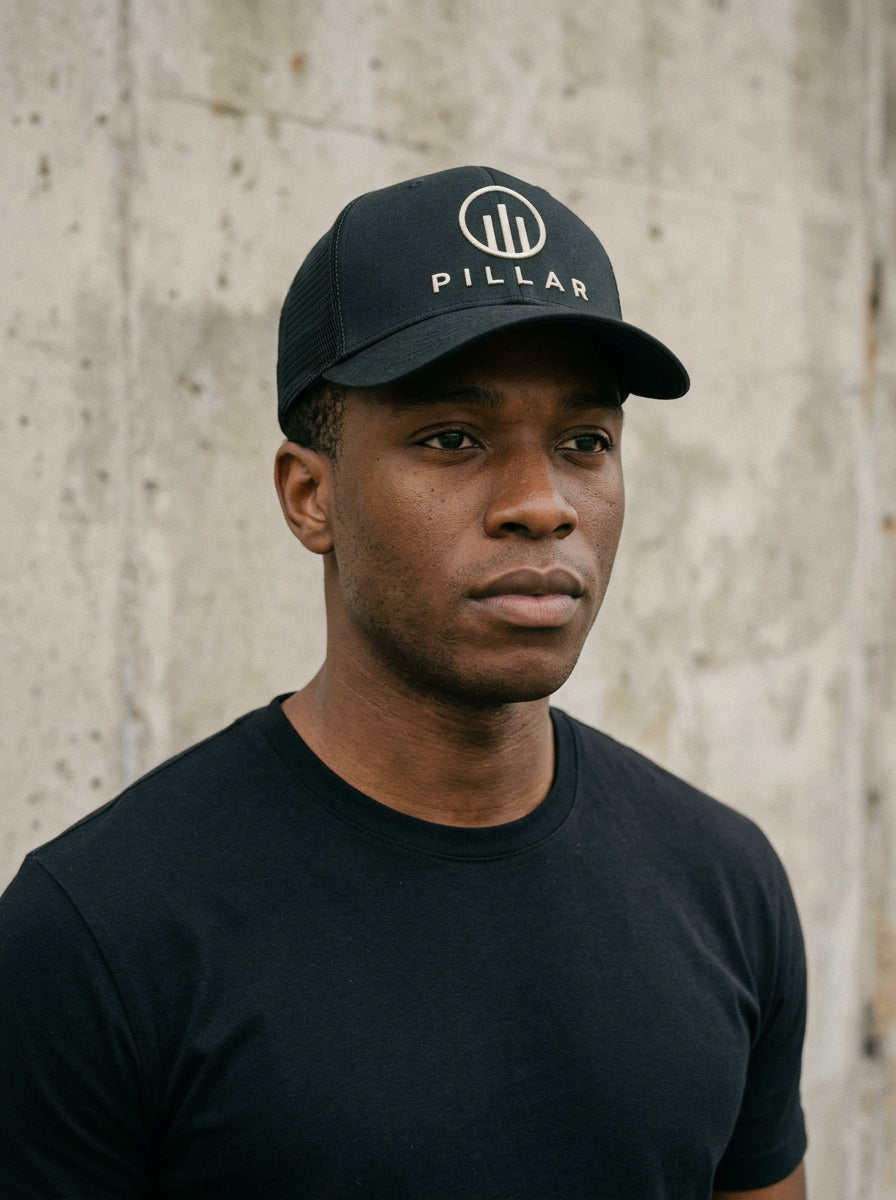 Model wearing the black PILLAR Trucker