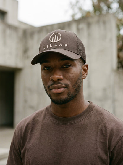 Model wearing the brown PILLAR Trucker