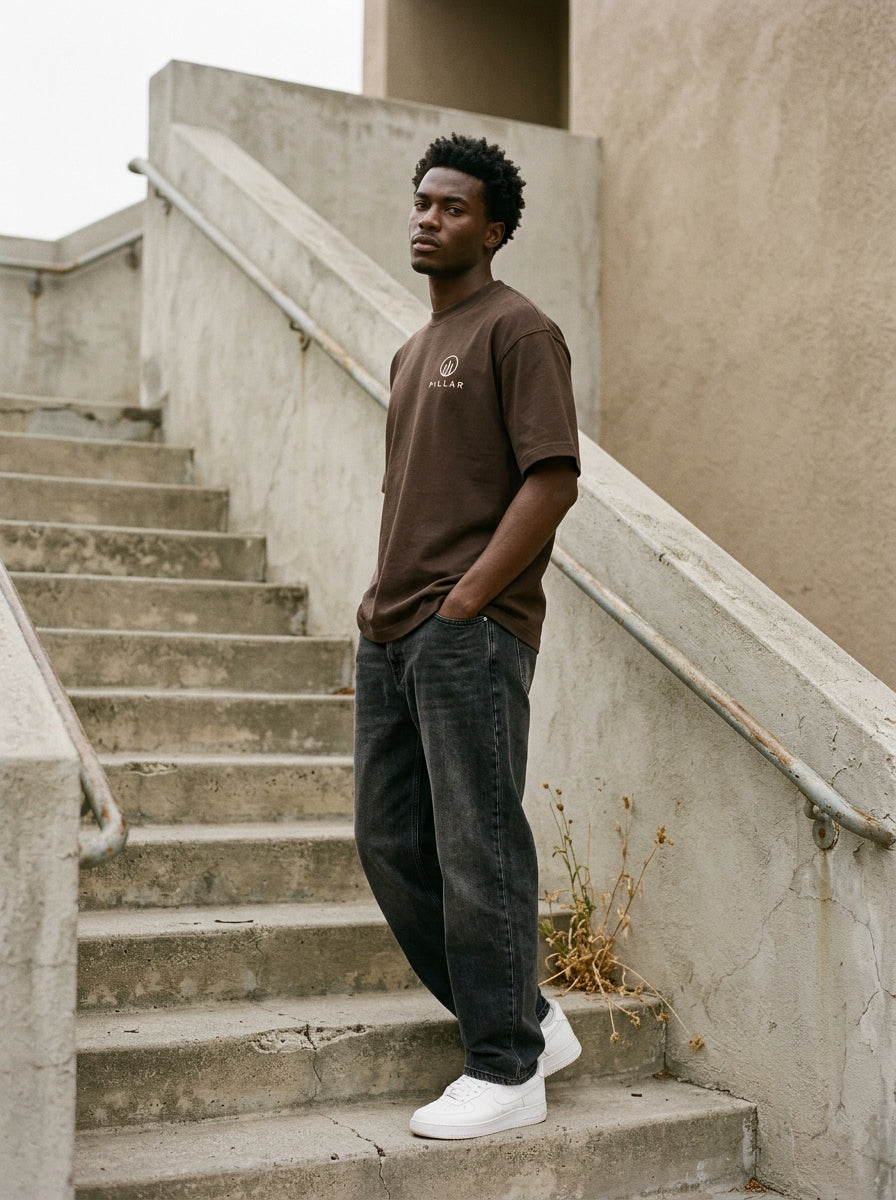 Model wearing the brown PILLAR Forged Foundation Tee