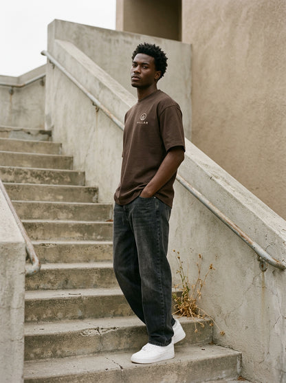 Model wearing the brown PILLAR Forged Foundation Tee